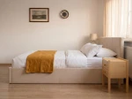 Čalúnená posteľ s úložným priestorom 120×200 cm Tilo Velvet – Béžová